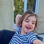 casual, chair, child, cute, daylight, expression, face, hair, happy, human, joy, laughing, outdoor, person, playful, portrait, smiling, striped_shirt, wicker, young