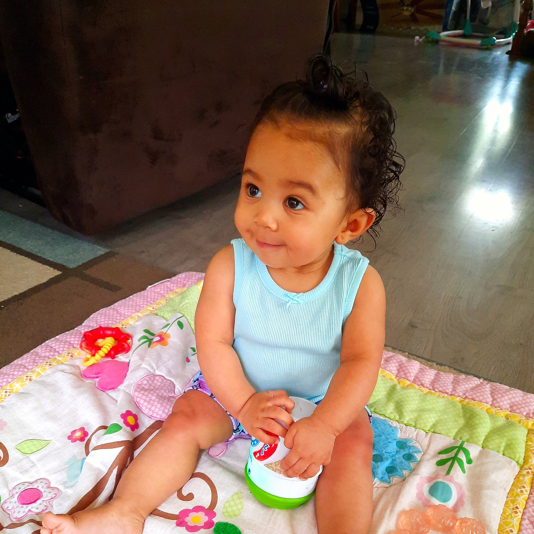 True is registered to the contest to win money with this photo: baby, baby_toddler_clothing, cheek, child, flooring, fun, hairstyle, happy, hardwood, iris, person, pink, play, room, sitting, skin, smile, sweetness, toddler, wood