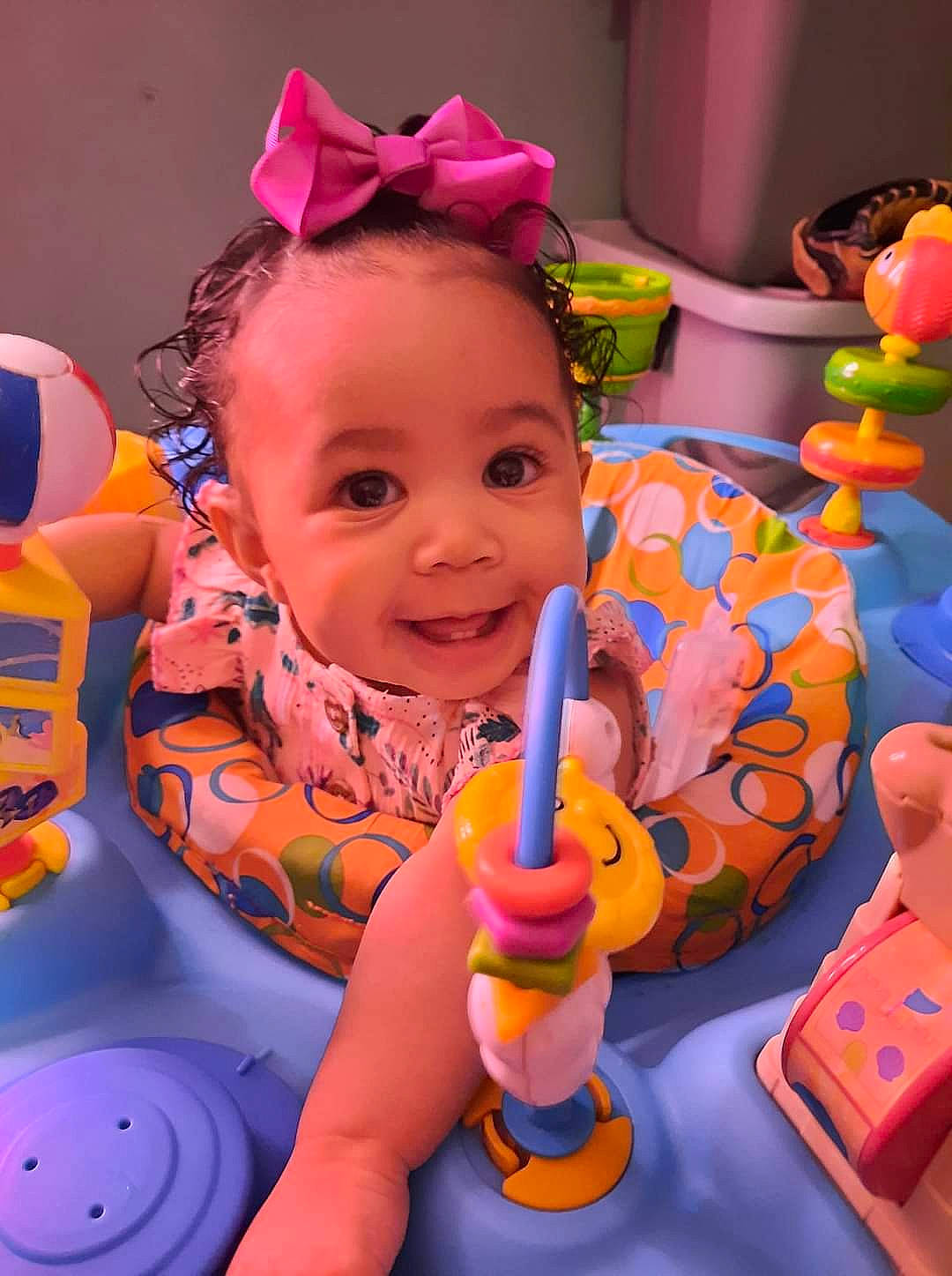 True is registered to the contest to win money with this photo: baby, baby_playing_with_toys, baby_products, baby_toddler_clothing, child, face, facial_expression, fun, happy, joy, orange, organ, person, photograph, pink, product, purple, skin, smile, toddler