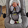 baby, sleeping, baby_rocker, gray, infant, indoor, wooden_floor, cozy, child, peaceful, soft_lighting, home_interior, minimalistic, face, person, seat, comfort, relaxation, cute, small