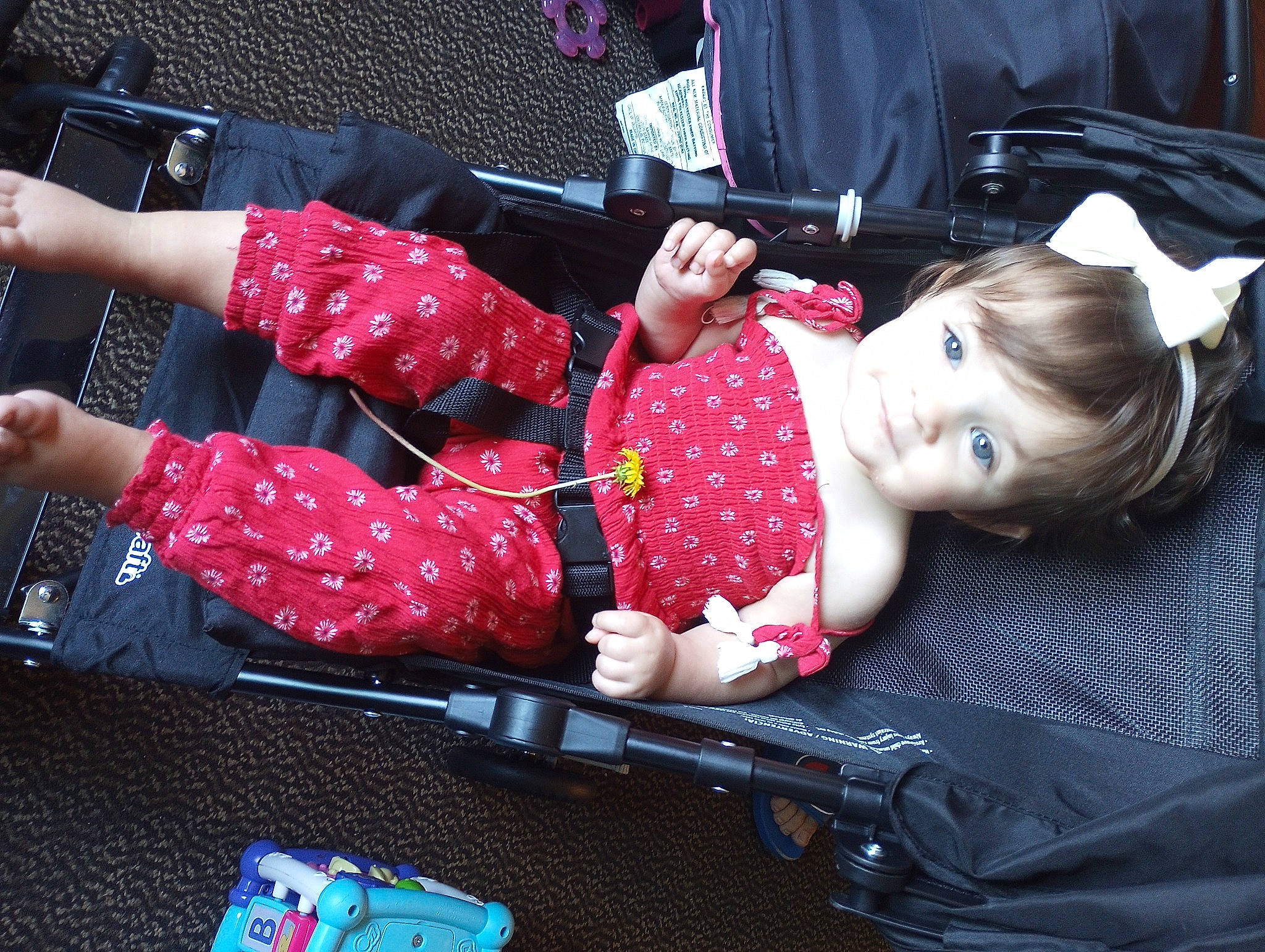 Makenzie is registered to the contest to win money with this photo: baby, baby_carriage, baby_products, baby_toddler_clothing, child, comfort, event, fun, gesture, happy, human_leg, lap, pattern, person, pink, sitting, sleeve, smile, thigh, toddler