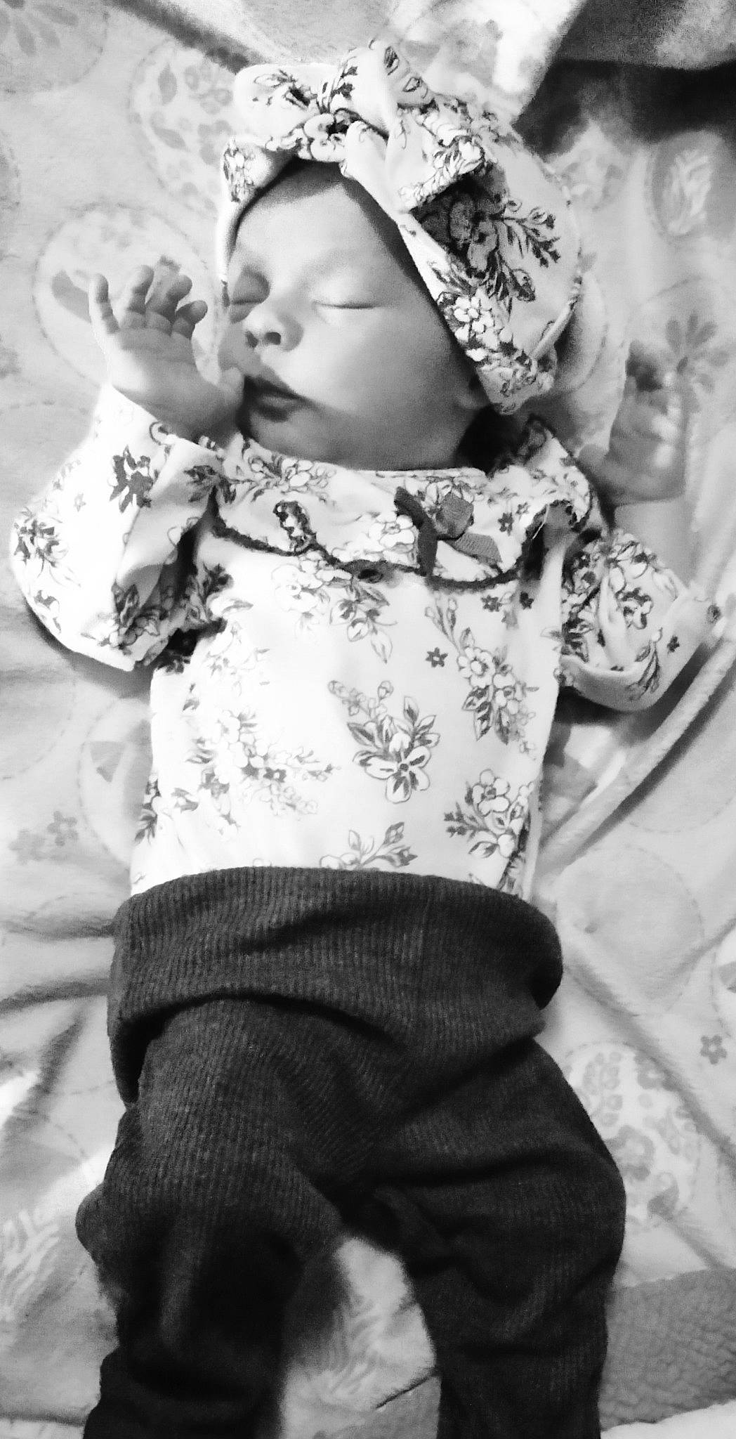 Makenzie is registered to the contest to win money with this photo: arm, baby, baby_toddler_clothing, black, black_and_white, clothing, eye, facial_expression, gesture, hand, happy, headgear, human, interaction, photograph, skin, sleeve, style, toddler, white