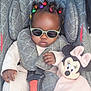 accessory, baby, baby_clothes, car_seat, child, clothing, colorful_hair_ties, cute, fashionable, indoors, infant, minnie_mouse, person, plush_toy, portrait, relaxed, seat_belt, small_child, soft_toy, sunglasses