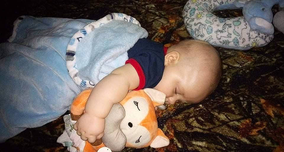 Brandon is registered to the contest to win money with this photo: baby, baby_toddler_clothing, bedtime, cheek, child, comfort, doll, fun, grass, happy, linens, mammal, mouth, nap, person, room, sitting, sleep, toddler, toy