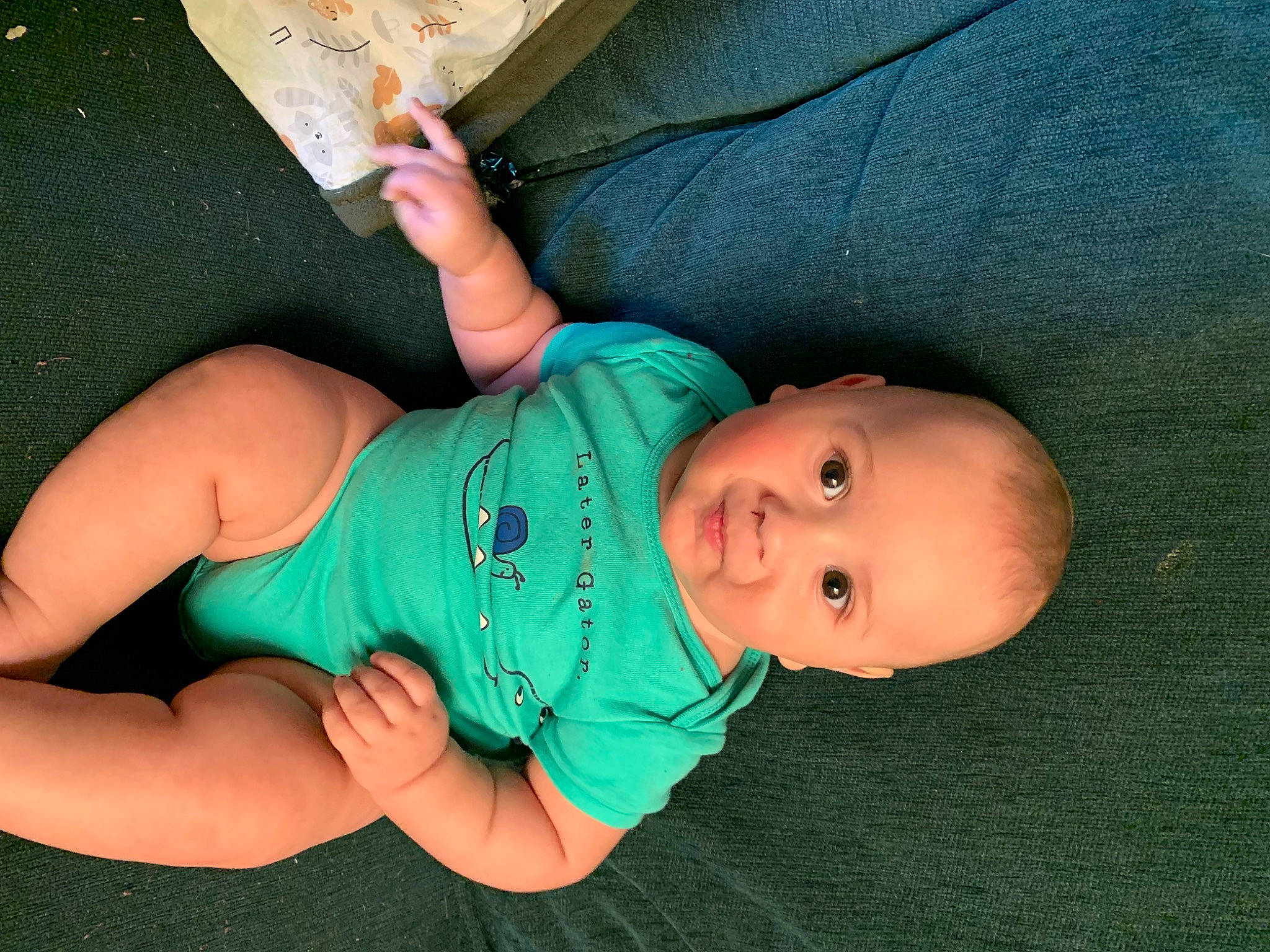 Royson is registered to the contest to win money with this photo: arm, baby, baby_products, baby_toddler_clothing, comfort, elbow, eye, finger, foot, gesture, grass, hand, human_leg, joint, leg, nail, person, sleeve, thumb, toddler