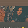 animal, bed, blanket, brown_hair, casual, dog, ears, face, furniture, happy, indoor, pet, portrait, selfie, shirt, smile, text_overlay, wall, woman, young_adult