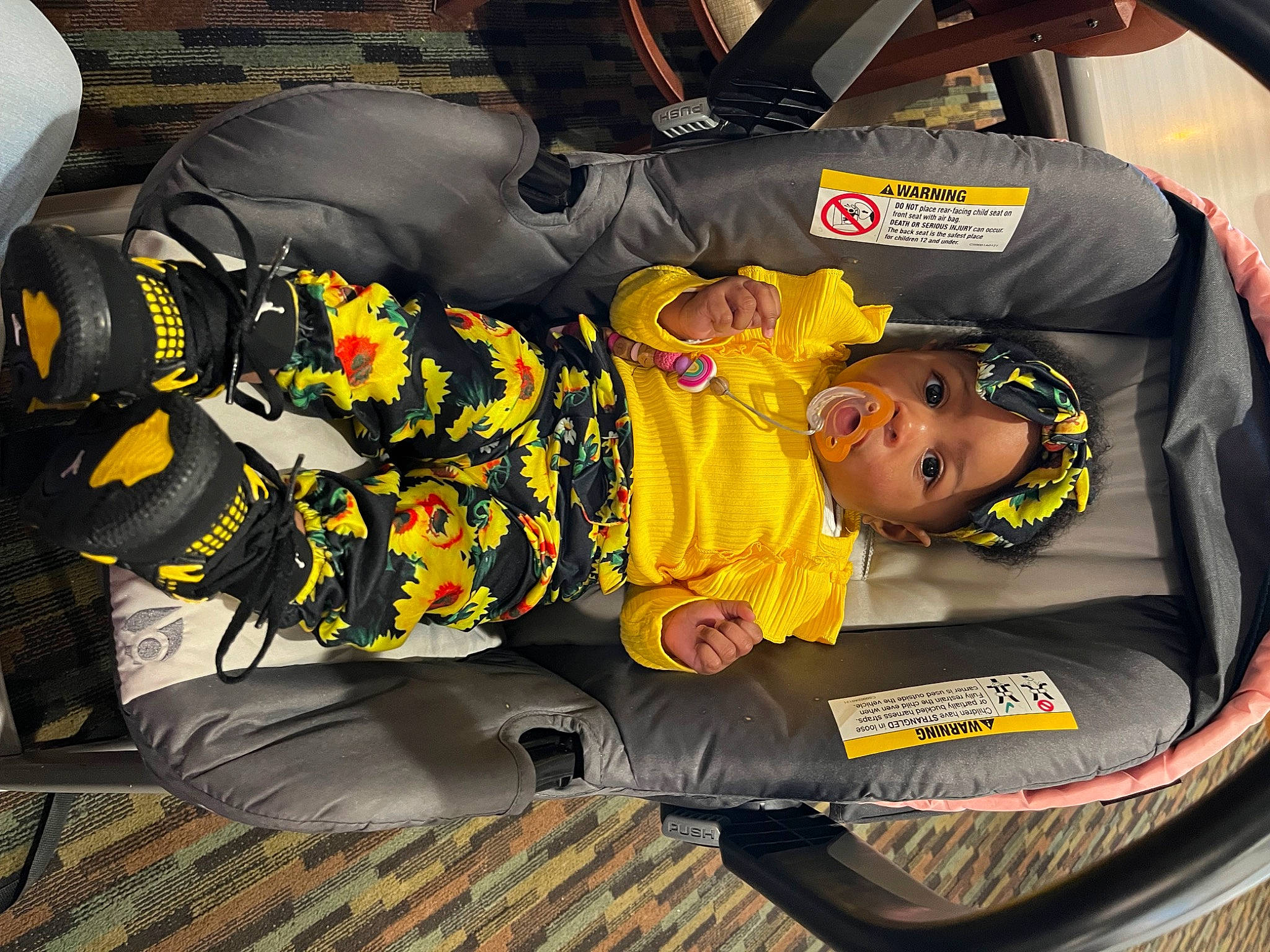 Raelyn is registered to the contest to win money with this photo: auto_part, baby_products, bag, car_seat, child, comfort, family_car, fun, headwear, luggage_and_bags, motor_vehicle, person, personal_protective_equipment, sitting, toddler, yellow