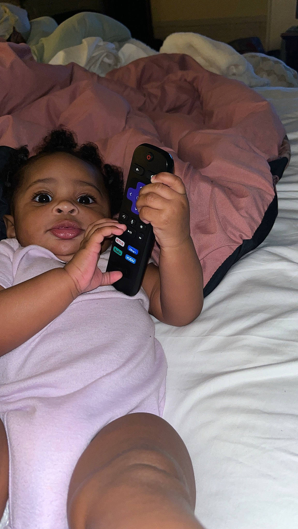 Raelyn is registered to the contest to win money with this photo: baby, camera, child, comfort, drinkware, event, finger, fun, gadget, hair, happy, head, mouth, nail, person, sitting, skin, thigh, thumb, toddler