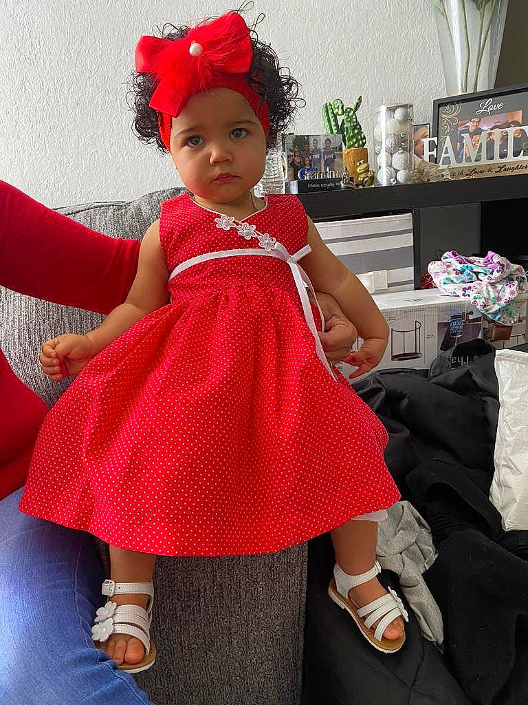 Esmeralda is registered to the contest to win money with this photo: baby, baby_toddler_clothing, costume_hat, day_dress, dress, event, fashion_design, formal_wear, fun, happy, hat, headpiece, headwear, magenta, one_piece_garment, pattern, person, pink, shoe, sleeve