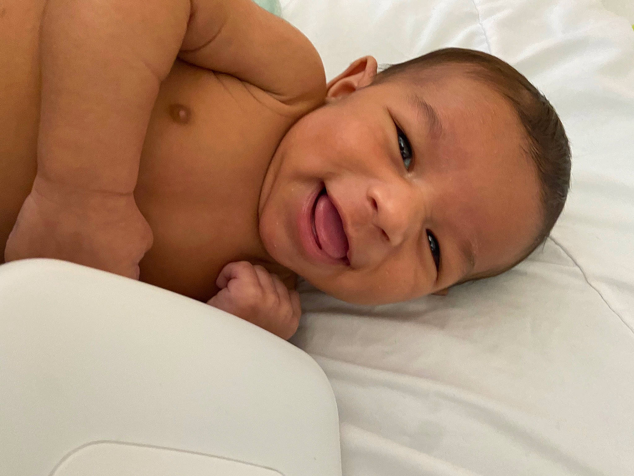 Kenny is registered to the contest to win money with this photo: baby, cheek, comfort, eye, eyelash, finger, flash_photography, gesture, happy, head, iris, linens, lip, mouth, neck, nose, person, skin, smile, stomach