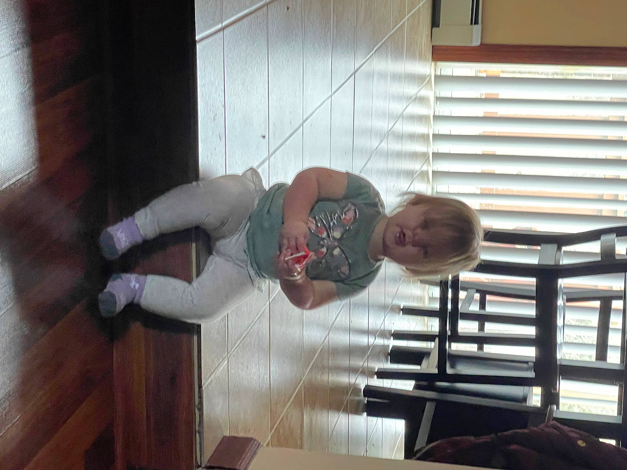 Layla is registered to the contest to win money with this photo: child, comfort, elbow, floor, flooring, handrail, hardwood, human_leg, metal, person, room, sitting, thigh, toddler, varnish, wood