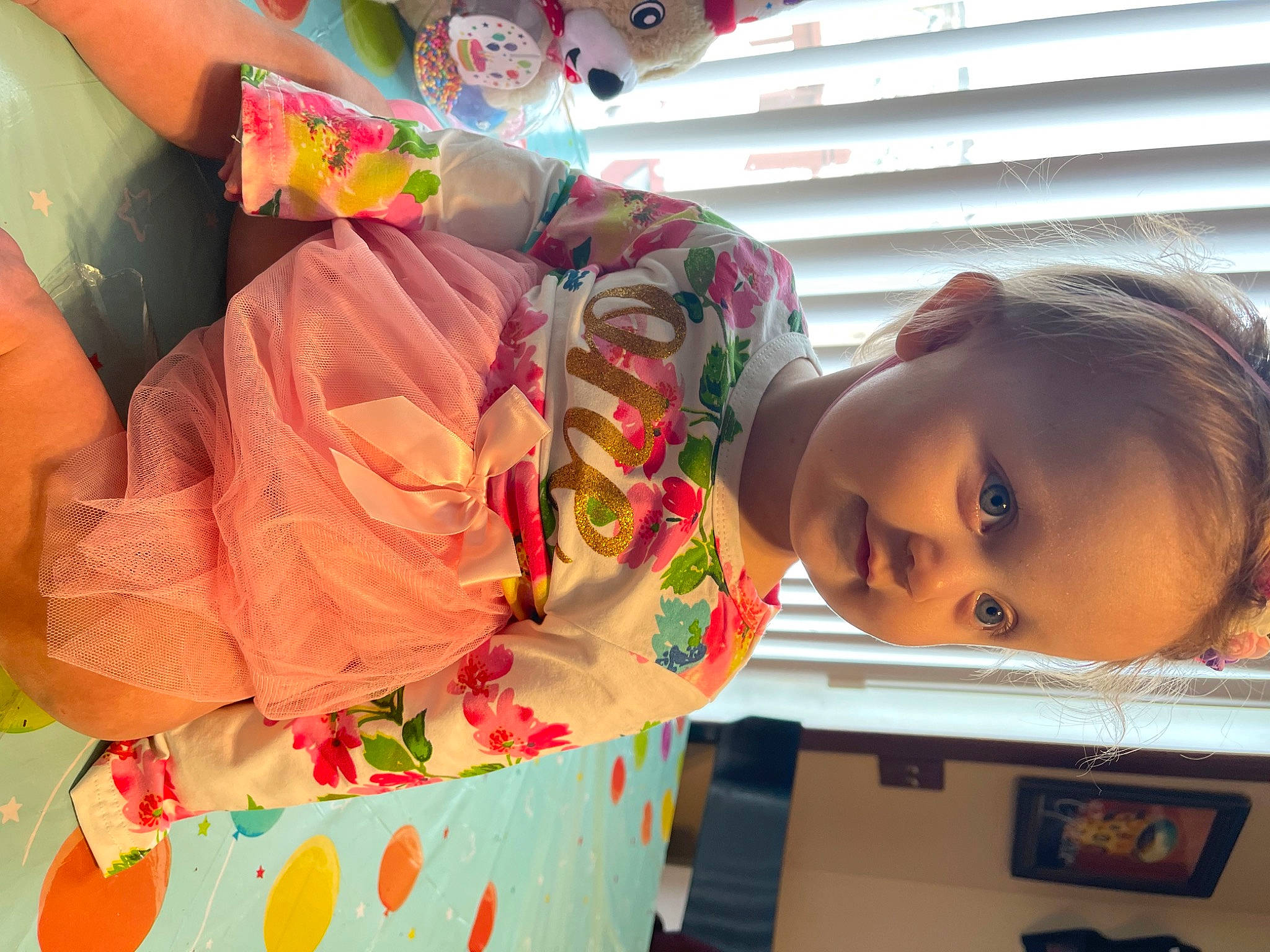 Layla is registered to the contest to win money with this photo: adaptation, baby, child, facial_expression, fun, happy, leisure, mouth, party, party_supply, pattern, peach, person, pink, plant, play, room, smile, snapshot, toddler