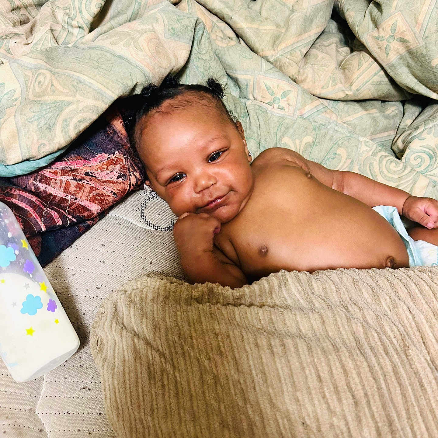 Josiah joined the competition — help win amazing prizes! baby, infant, blanket, bed, bottle, diaper, face, person, skin, cute, resting, indoors, furniture, sleepwear, comfort, child, portrait, young, relaxation, cozy