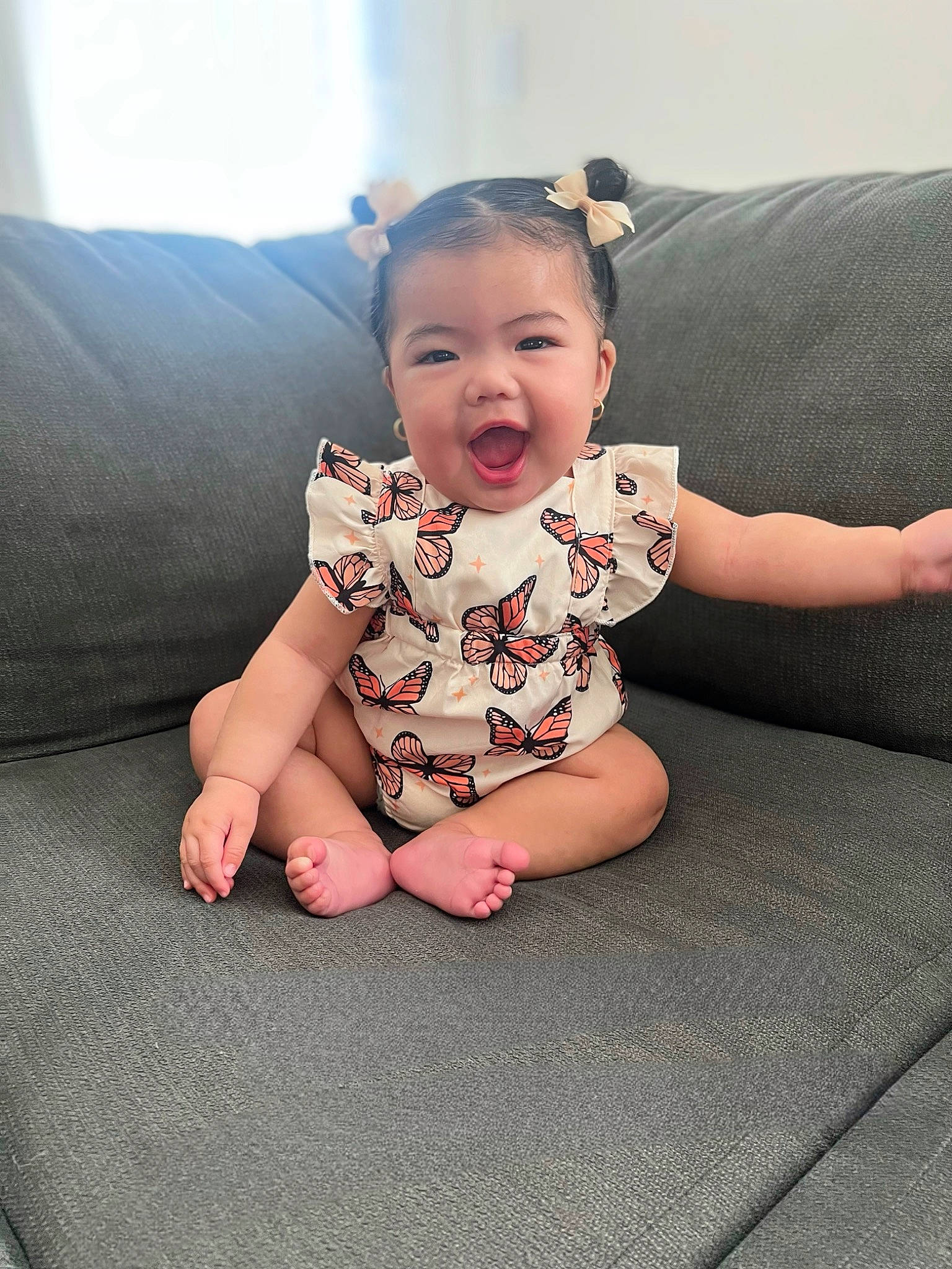 Kaelani joined the competition — help win amazing prizes! arm, baby, baby_toddler_clothing, cheek, chin, comfort, couch, eye, face, flash_photography, happy, head, human_body, neck, pattern, person, sitting, skin, sleeve, smile