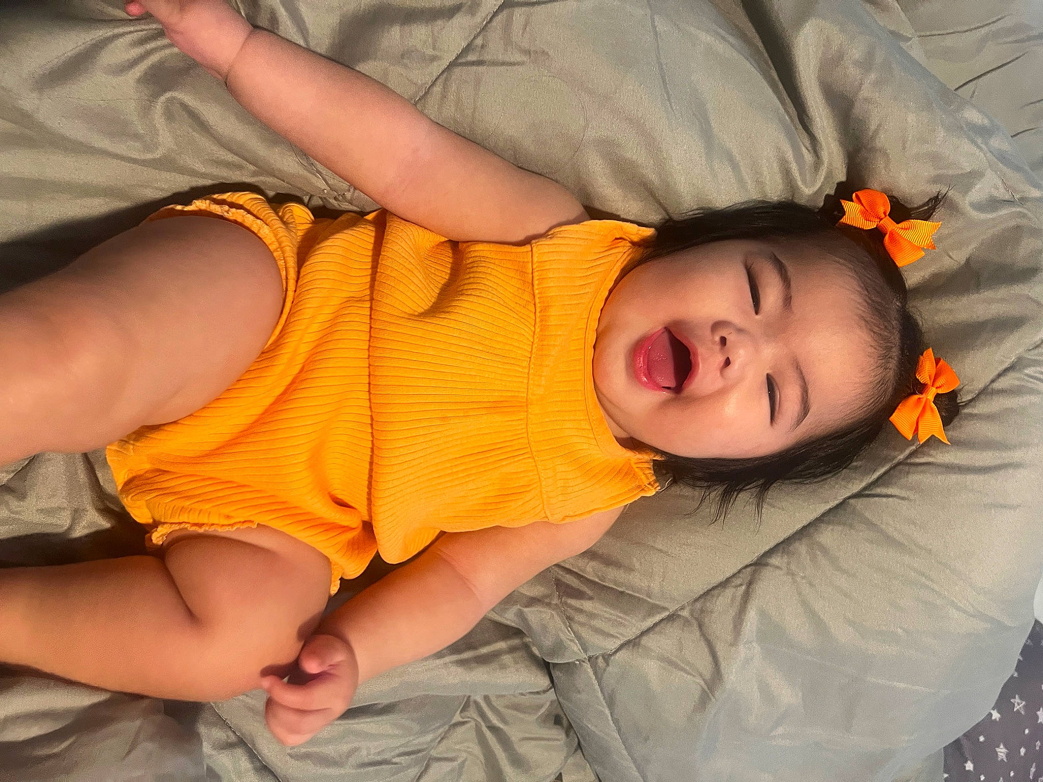 Kaelani is registered to the contest to win money with this photo: cheek, child, comfort, elbow, eye, fun, gesture, human_body, joint, mammal, mouth, nose, orange, person, plant, skin, smile, thigh, toddler, tree