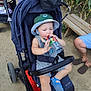 toddler, child, stroller, hat, water_bottle, outdoor, bench, dirt_path, sandals, clothing, person, baby, sun_hat, footwear, greenery, adult, legs, relaxing, summer, daylight