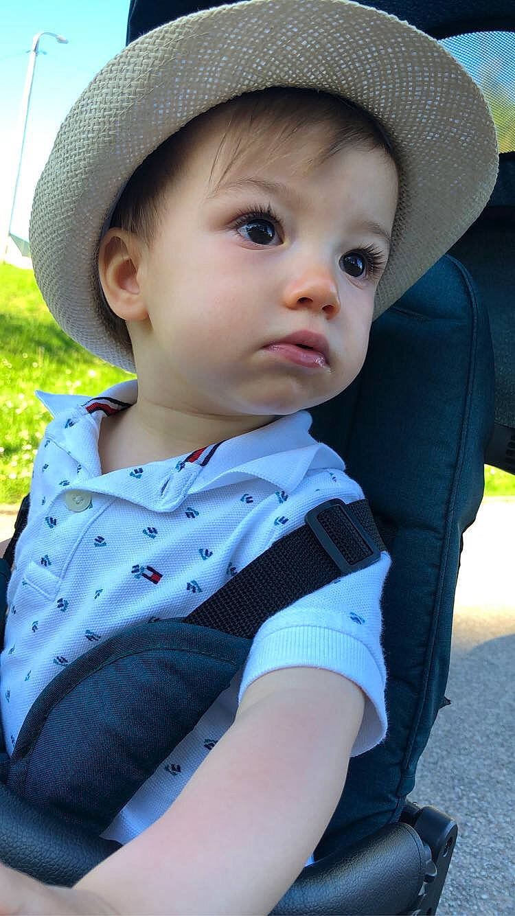 Louis a rejoint le concours — aidez-le/la à gagner de superbes lots ! baby, baby_toddler_clothing, cap, child, chin, cool, electric_blue, facial_expression, fashion_accessory, grass, hat, lip, outerwear, pattern, person, sitting, skin, sleeve, sun_hat, toddler