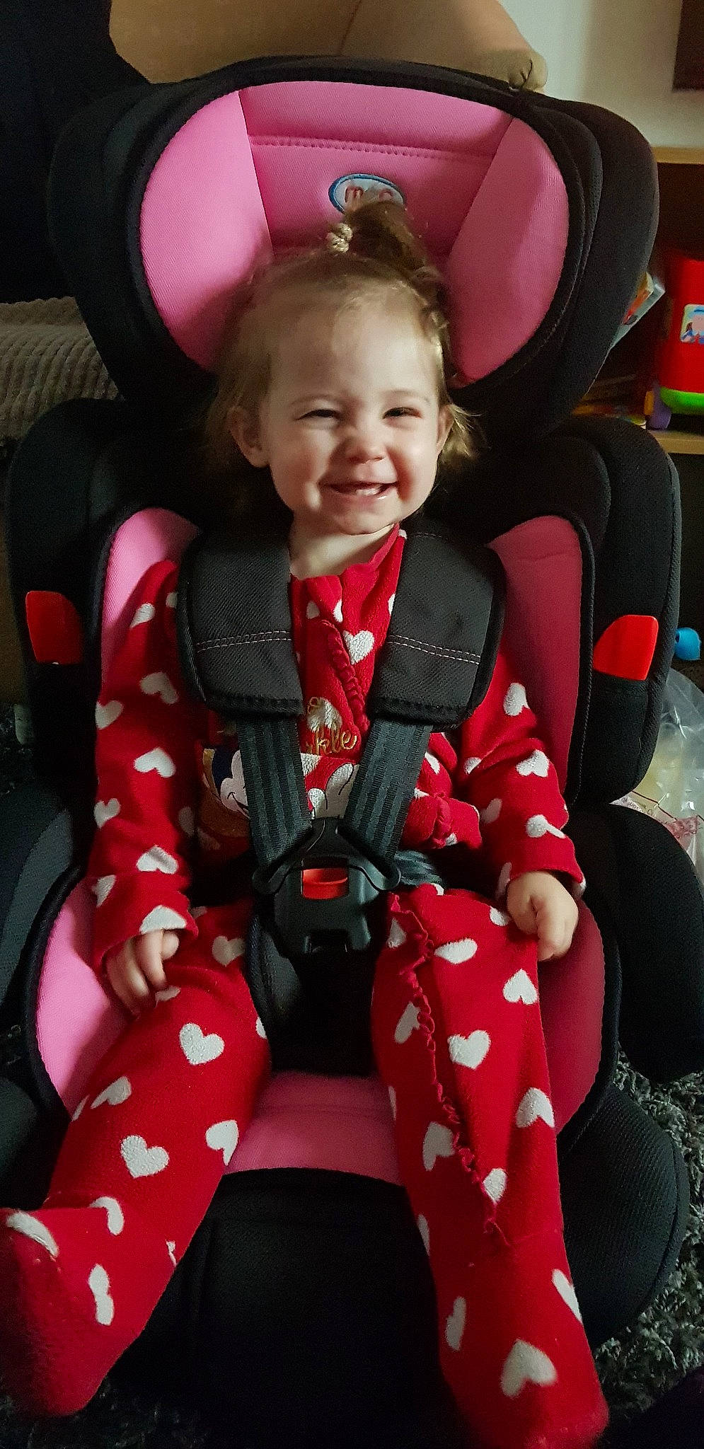Esmai is registered to the contest to win money with this photo: baby_in_car_seat, car_seat, child, joy, person, pink, red, sitting, smile, toddler