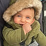 baby, child, hooded_jacket, green_jacket, smiling, stroller, blanket, fur_hood, cute, outdoor, happy, portrait, infant, cold_weather, warm_clothing, baby_hand, blue_eyes, closeup, face, person