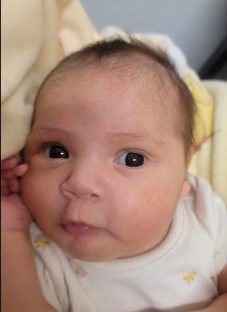 Kiara is registered to the contest to win money with this photo: baby, infant, face, eyes, skin, onesie, blanket, closeup, portrait, newborn, cute, child, person, soft, young, sleepwear, head, expression, adorable, indoors