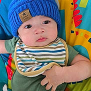 Clarence Axel is registered to the contest to win money with this photo: baby, blue_hat, child, colorful_playmat, comfort, cute, expression, fabric, face, giraffe_design, green_onesie, hand, indoors, infant, knit_hat, playtime, seated, striped_bib, toy, young