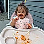 Viviana is registered to the contest to win money with this photo: toddler, child, high_chair, bib, pasta, messy, food, eating, happy, curly_hair, outdoor, patio, gray_siding, plastic_tray, fork, smiling, clothing, young_child, meal_time, baby