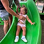 Viviana joined the competition — help win amazing prizes! toddler, child, slide, playground, green_slide, smiling, fun, outdoor, adult_hand, support, shorts, sneakers, socks, tattoo, summer, play, joy, park, person, curly_hair
