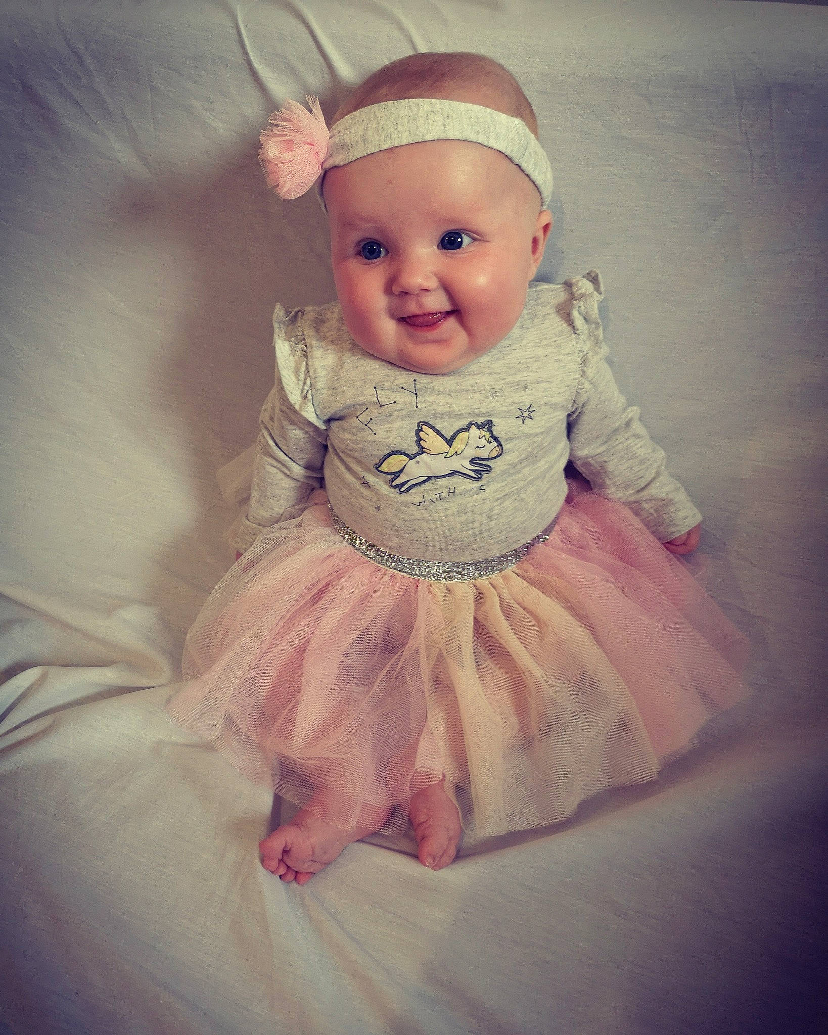 Malya participe au concours pour gagner de l'argent avec cette photo : baby, baby_products, baby_toddler_clothing, ballet_tutu, cheek, child, clothing, costume, dress, eye, face, hair_accessory, head, headgear, iris, joy, person, pink, product, skin