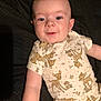 Colby is registered to the contest to win money with this photo: apparel, baby, child, cute, deer_print, expression, face, happy, indoors, infant, lying_down, onesie, person, portrait, short_sleeves, skin, sleepwear, smiling, toddler, young_child
