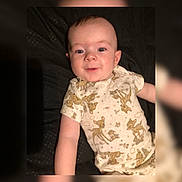 Colby joined the competition — help win amazing prizes! arm, baby, child, clothing, cute, deer_print, eyes, fabric, face, happy, indoors, infant, lying_down, onesie, pattern, person, portrait, skin, smile, young