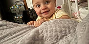 Journiee is registered to the contest to win money with this photo: baby, bedroom, child, curiosity, cute, door, expression, face, furniture, hands, happy, home, indoors, infant, lighting, peek, person, quilt, room, smile