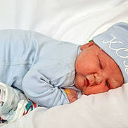 Kody is registered to the contest to win money with this photo: baby, bed, blanket, blue_pajamas, child, comfort, cozy, cute, face, hat, indoors, infant, lying_down, newborn, peaceful, resting, skin, sleeping, soft, toddler