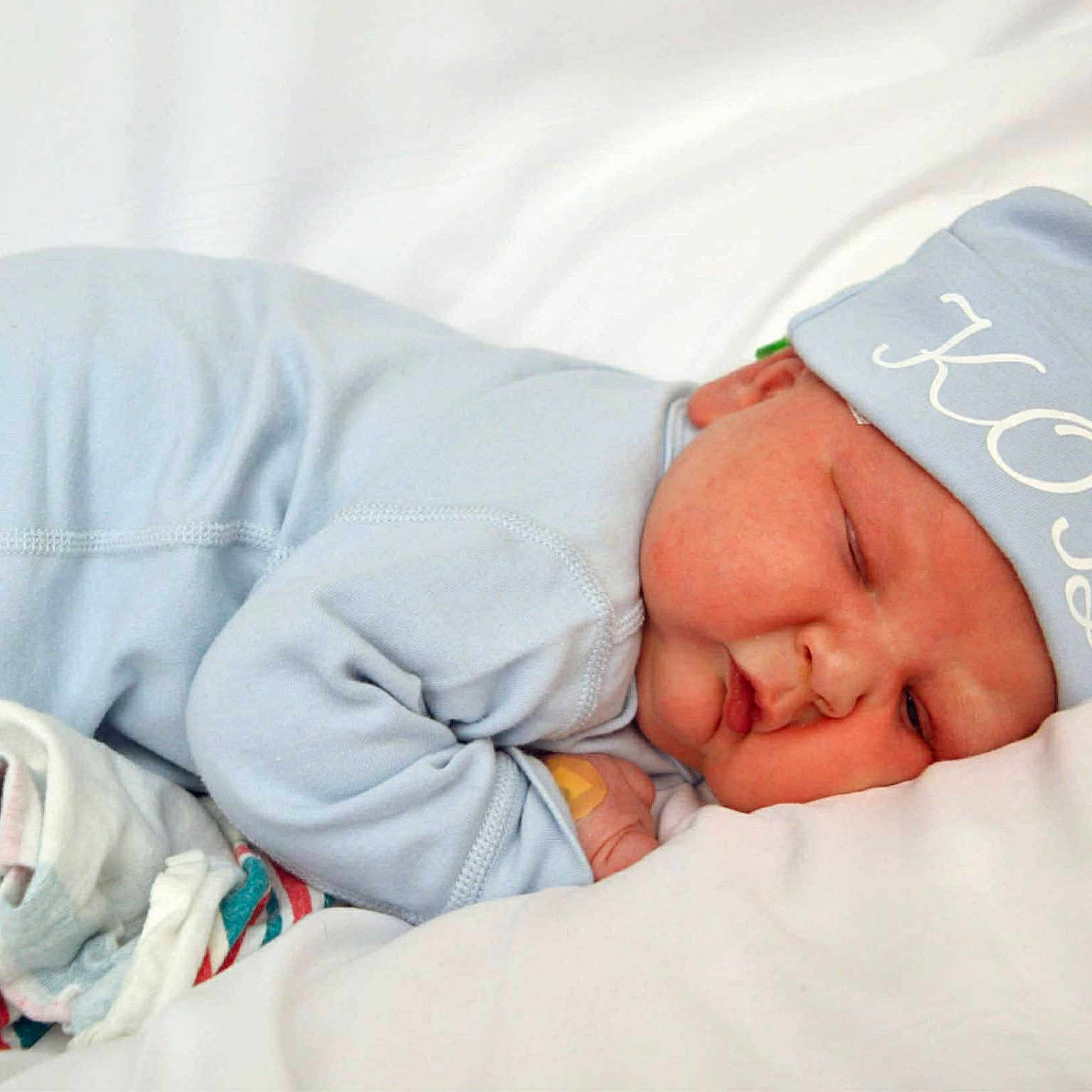 Kody is registered to the contest to win money with this photo: baby, bed, blanket, blue_pajamas, child, comfort, cozy, cute, face, hat, indoors, infant, lying_down, newborn, peaceful, resting, skin, sleeping, soft, toddler