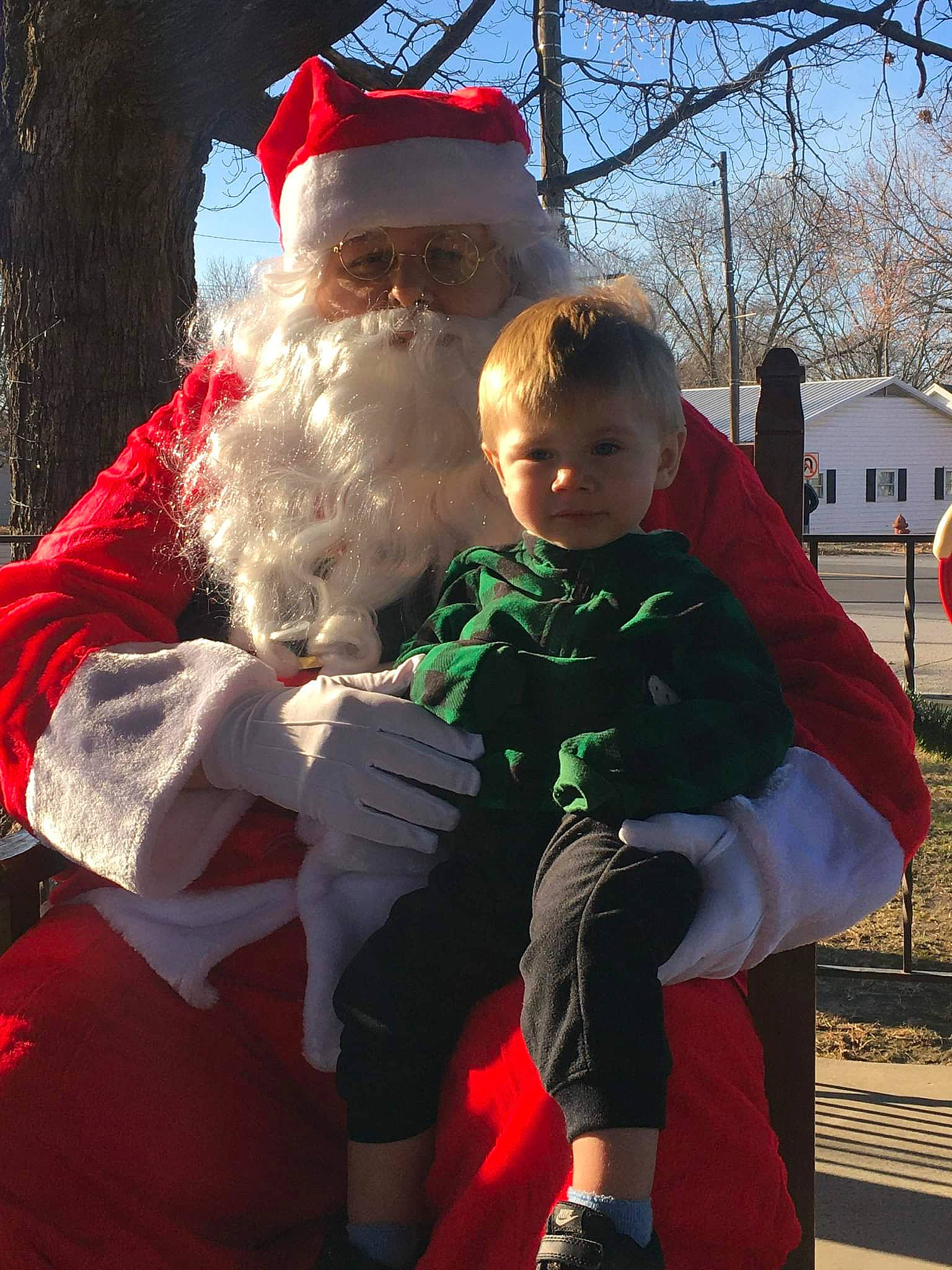 Waylyn is registered to the contest to win money with this photo: baby, beard, child, christmas, event, face, facial_expression, facial_hair, fictional_character, fun, happy, holiday, lap, person, recreation, santa_claus, sitting, sky, standing, toddler