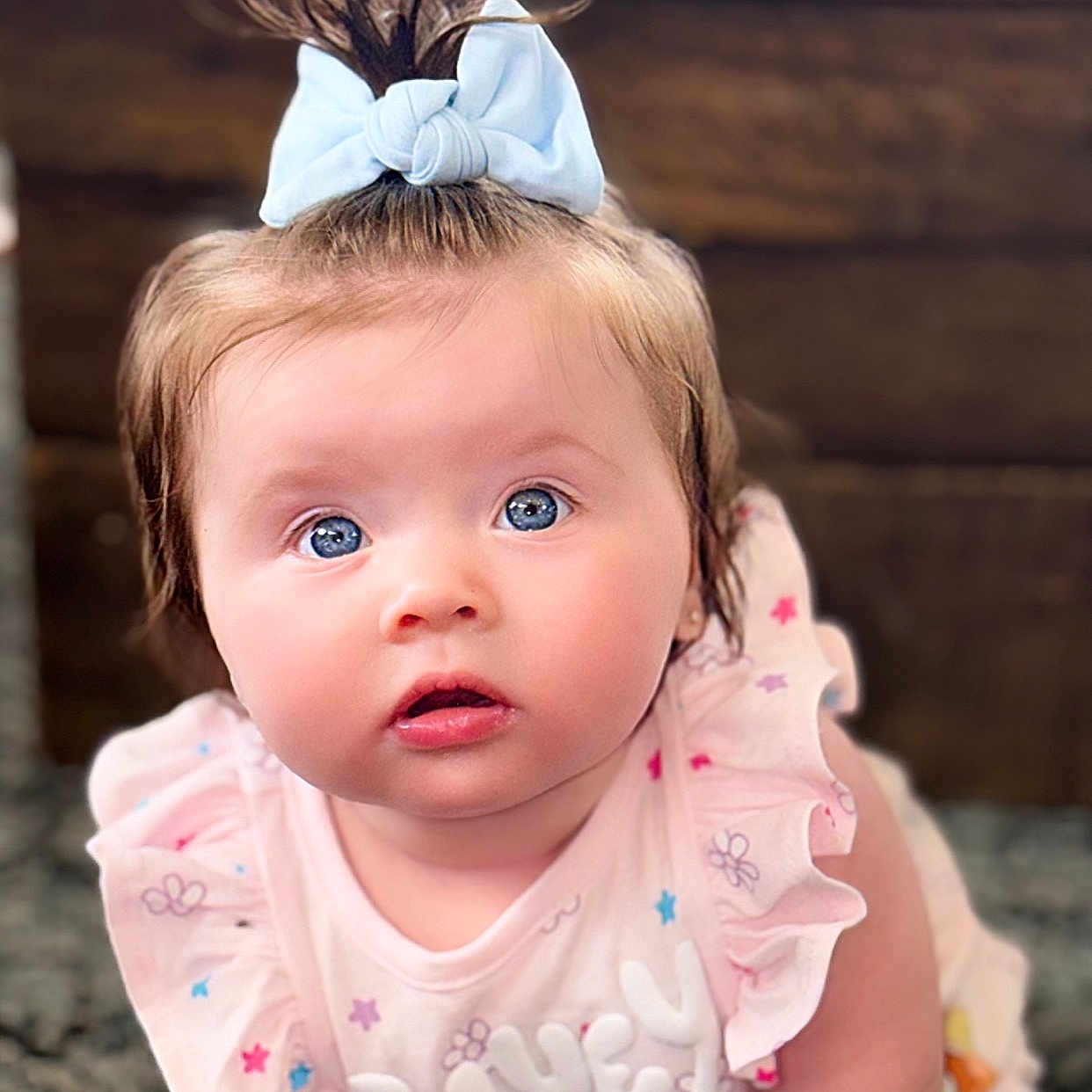 Elianna joined the competition — help win amazing prizes! accessories, baby, blonde, clothing, doll, dress, face, frown, hair, hat, head, headband, jewelry, newborn, person, photography, portrait, sitting, toy, wood