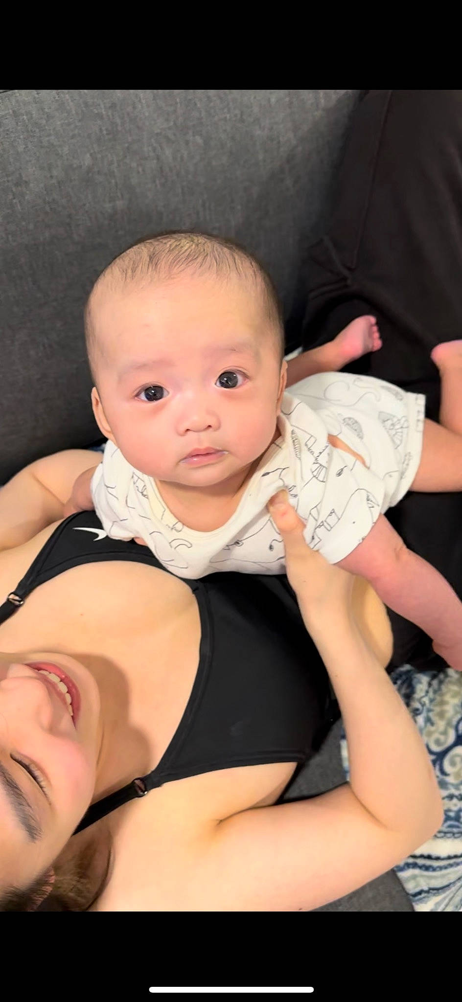 Joe is registered to the contest to win money with this photo: baby, baby_toddler_clothing, cheek, chin, comfort, elbow, eye, finger, hairstyle, human_body, iris, joint, leg, neck, person, pink, shoulder, skin, sleeve, stomach