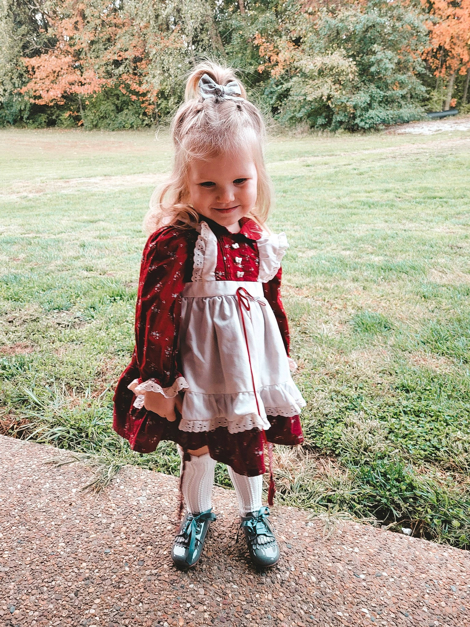 Nalani is registered to the contest to win money with this photo: baby, baby_toddler_clothing, botany, dress, face, fawn, grass, happy, human_body, joy, leaf, leg, mammal, nature, people_in_nature, person, plant, shoe, sleeve, smile