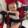baby, child, clothing, cute, expression, face, foot, handlebar, home, indoor, infant, light, person, playful, red, safety_bar, seat, smile, stroller, toddler