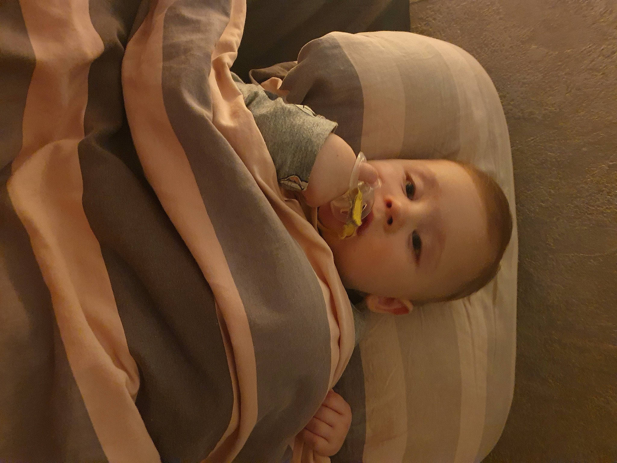 Kayden participe au concours pour gagner de l'argent avec cette photo : baby, baby_products, baby_safety, baby_sleeping, baby_toddler_clothing, child, comfort, linens, pattern, peach, person, personal_protective_equipment, room, sleep, sleeve, toddler, wood