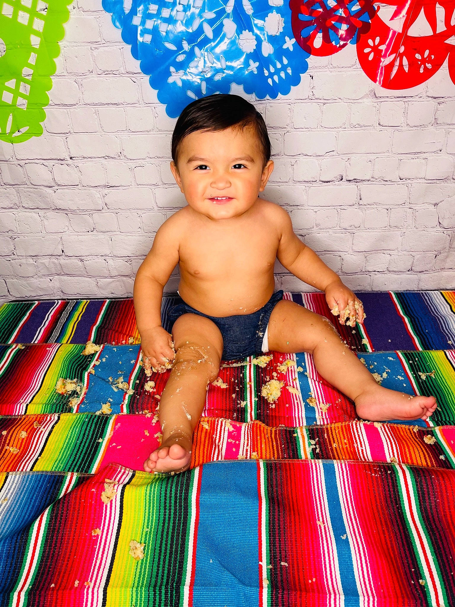 Gael is registered to the contest to win money with this photo: baby, baby_products, baby_toddler_clothing, blue, child, design, electric_blue, flooring, fun, happy, human_leg, leisure, linens, pattern, person, play, room, sitting, thigh, toddler
