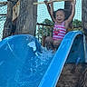 active, blue_slide, child, fun, happy, netting, outdoor, person, pink_swimsuit, play, playground, recreation, smiling, splash, summer, sunny, tree, water, water_slide, wood