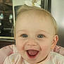 Bella is registered to the contest to win money with this photo: baby, child, closeup, cute, face, hair_bow, happy, high_chair, indoor, infant, joyful, kitchen, messy, mouth_open, person, pink_clothing, portrait, smiling, teeth, young_child