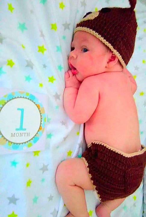 Ethan is registered to the contest to win money with this photo: child, clothing, finger, hair, hairstyle, hand, headwear, infant, mouth, person, pink, toddler