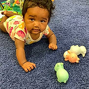 Rosalinda joined the competition — help win amazing prizes! animal_toy, baby, blue_carpet, carpet, child, colorful_clothing, crawling, curious, cute, expression, face, floor, hand, happy, indoor, infant, onesie, playtime, toy, young_child