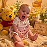 baby, blanket, child, cozy, cute, decor, fairy_lights, flowers, fur_rug, happy, honey_pot, indoors, infant, plush_toy, portrait, sitting, smiling, soft_lighting, winnie_the_pooh, wooden_sign