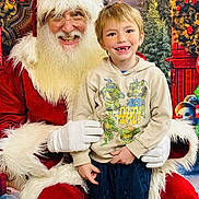 Alijah joined the competition — help win amazing prizes! child, boy, santa_claus, christmas, holiday, smile, happy, festive, costume, beard, glasses, lights, decorations, red_clothing, hoodie, indoor, portrait, cute, seasonal, celebration