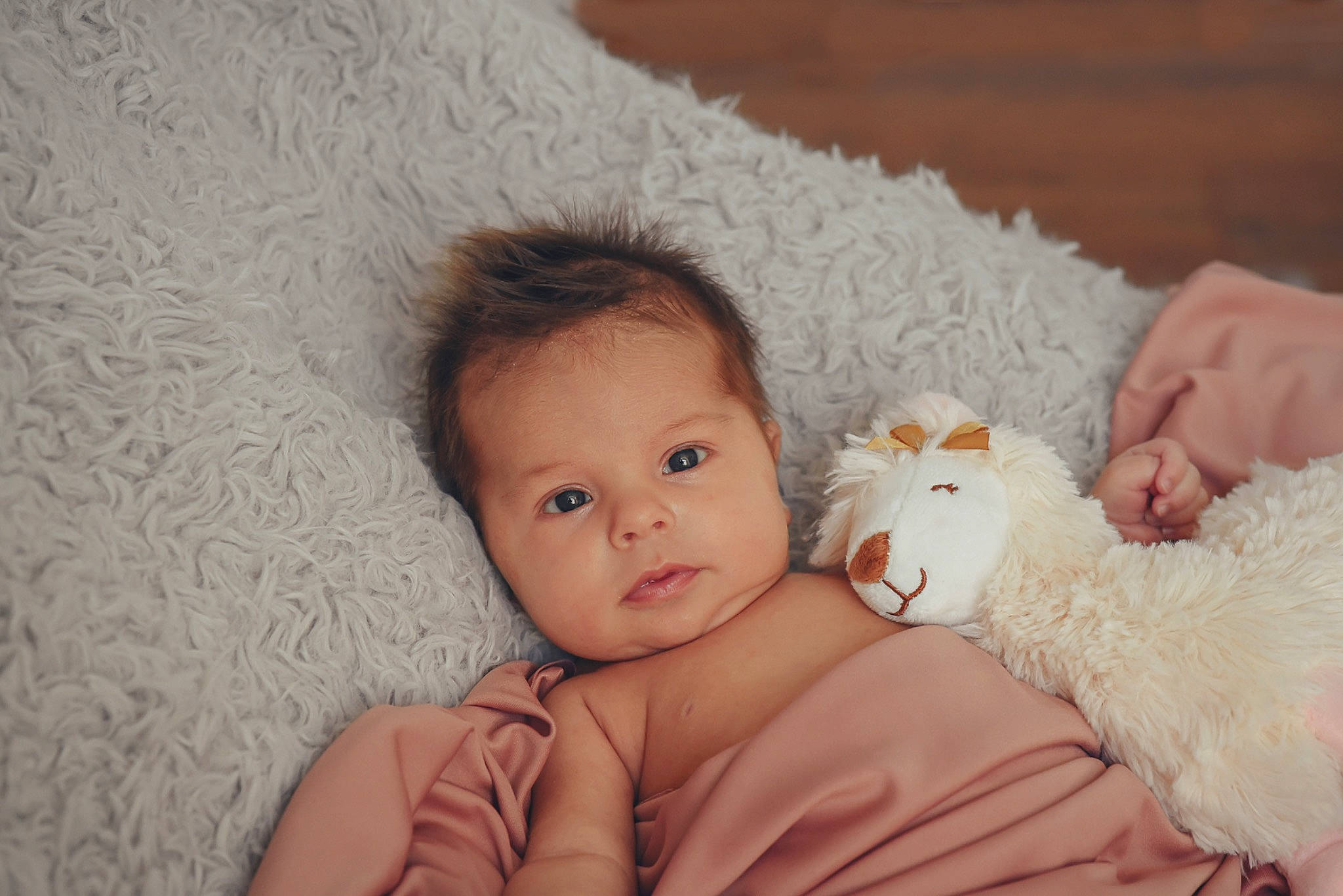 Everlee is registered to the contest to win money with this photo: baby, blanket, cheek, child, eye, fur, hand, person, pink, room, skin, textile, toddler, wool