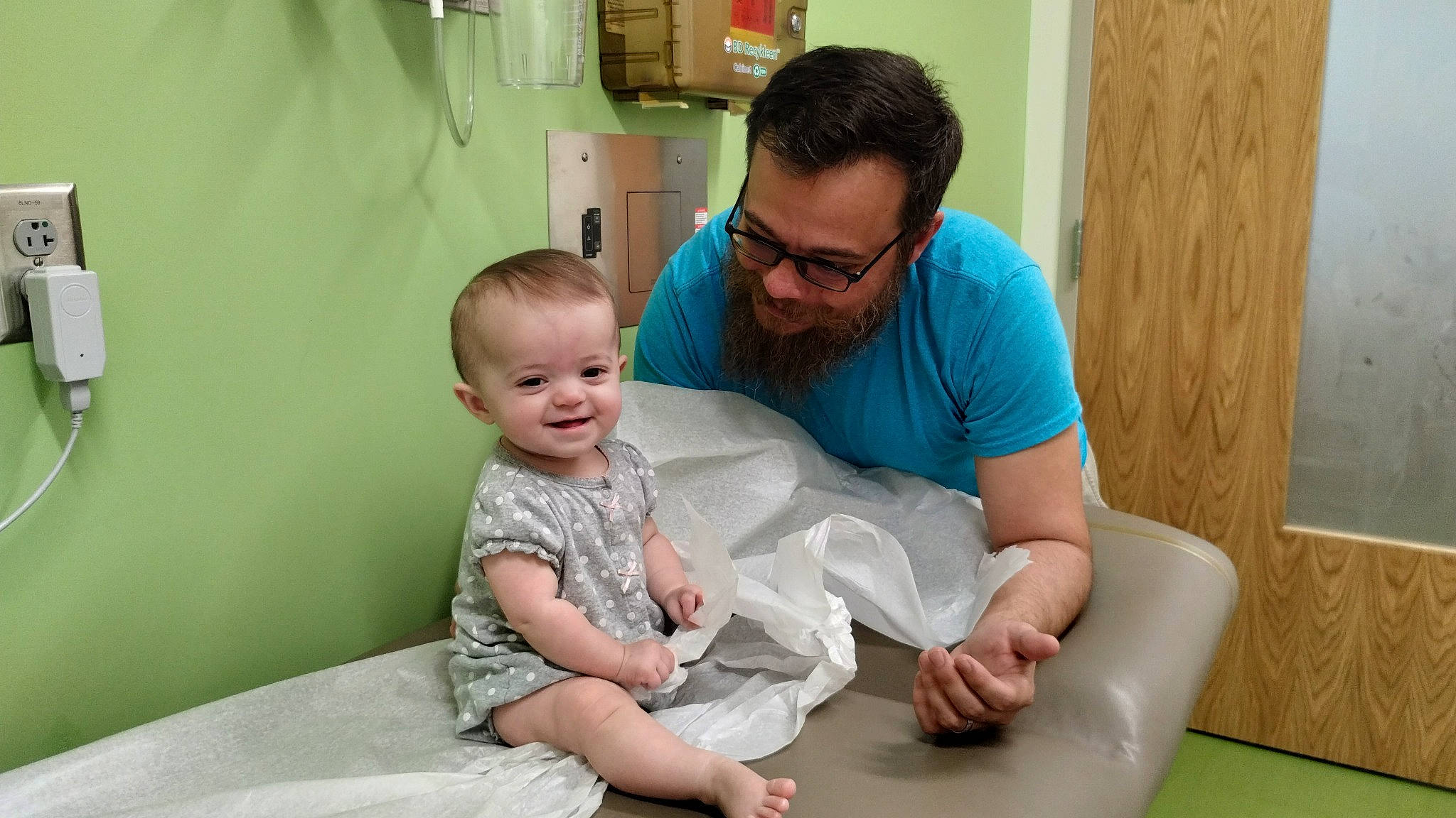 Cadence is registered to the contest to win money with this photo: baby, barefoot, child, comfort, elbow, event, fun, happy, health_care, joy, knee, lap, leisure, person, picture_frame, room, service, shorts, shoulder, sitting