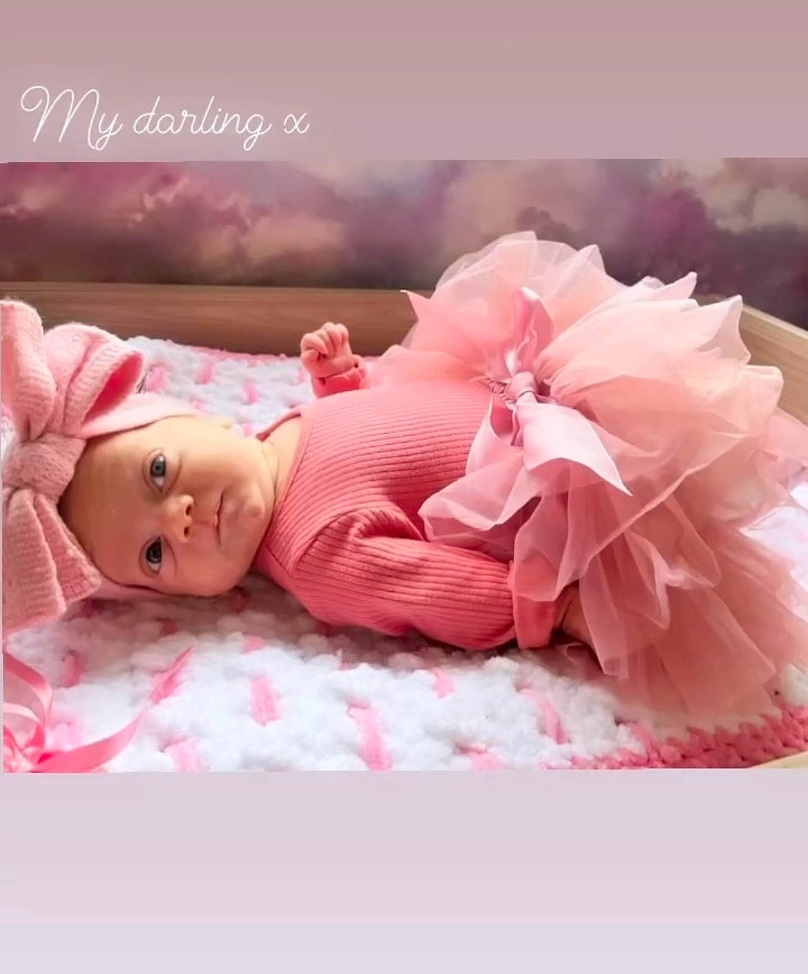 Lucia is registered to the contest to win money with this photo: baby, baby_sleeping, baby_toddler_clothing, bedding, comfort, dress, eyelash, fashion_accessory, flower, font, happy, headgear, headpiece, headwear, linens, magenta, peach, person, petal, pink
