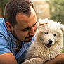 accessories, adult, animal, bodypart, canine, dog, eskimodog, face, head, husky, jewelry, male, man, necklace, person, pet, poodle, puppy, terrier, whitedog